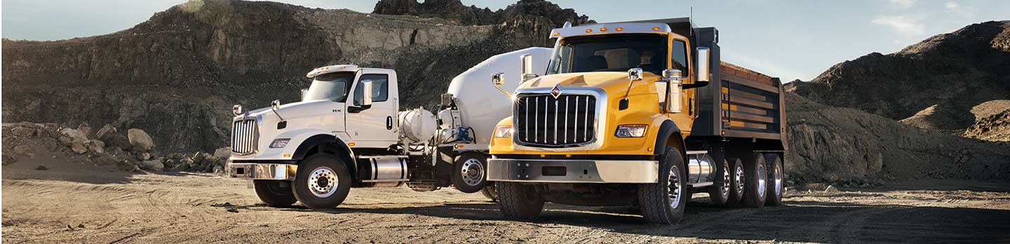 hx-trucks-s13-powertrain HX Dump Truck & Mixer Truck with S13 Powertrain engines at a work site.
